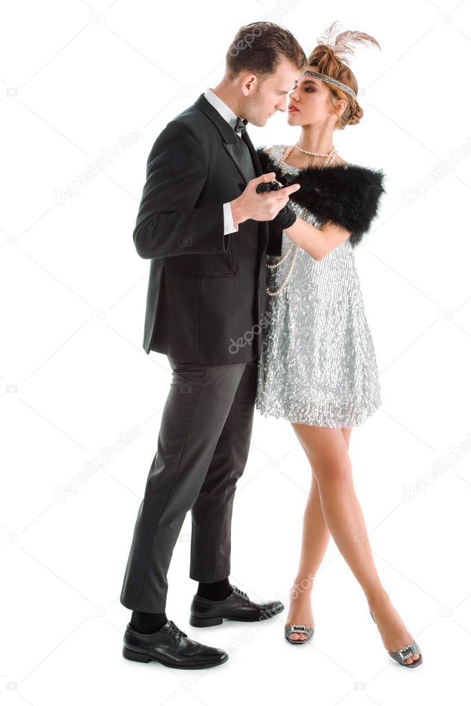 aristocratic man and woman holding hands and standing isolated on white 
