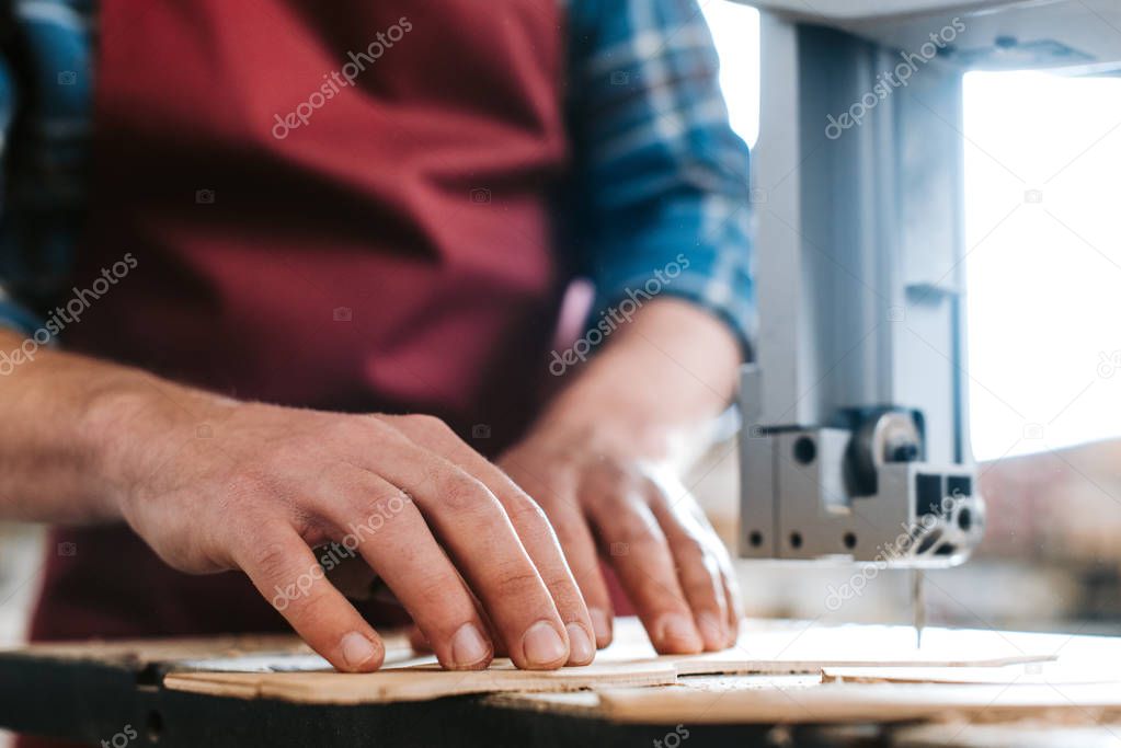 cropped view of carpenter standing near cnc machine 