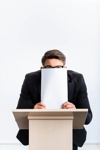 Scared Businessman Suit Standing Podium Tribune Obscuring Face Paper Conference — ストック写真