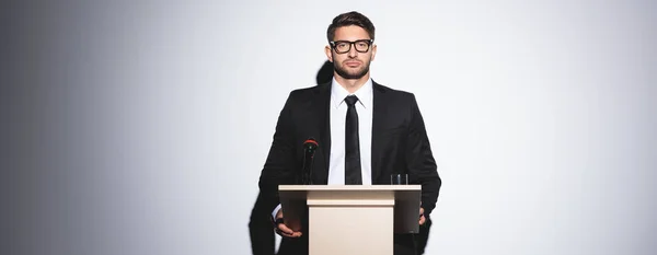 Panoramic Shot Businessman Suit Standing Podium Tribune Looking Camera Conference — Stock Photo, Image