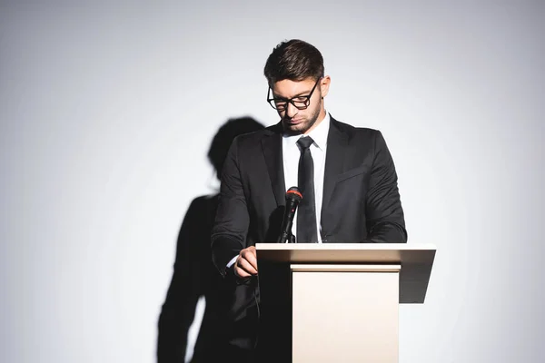 Biznesmen Garniturze Stojący Podium Trybuny Spoglądający Dół Podczas Konferencji Białym — Zdjęcie stockowe