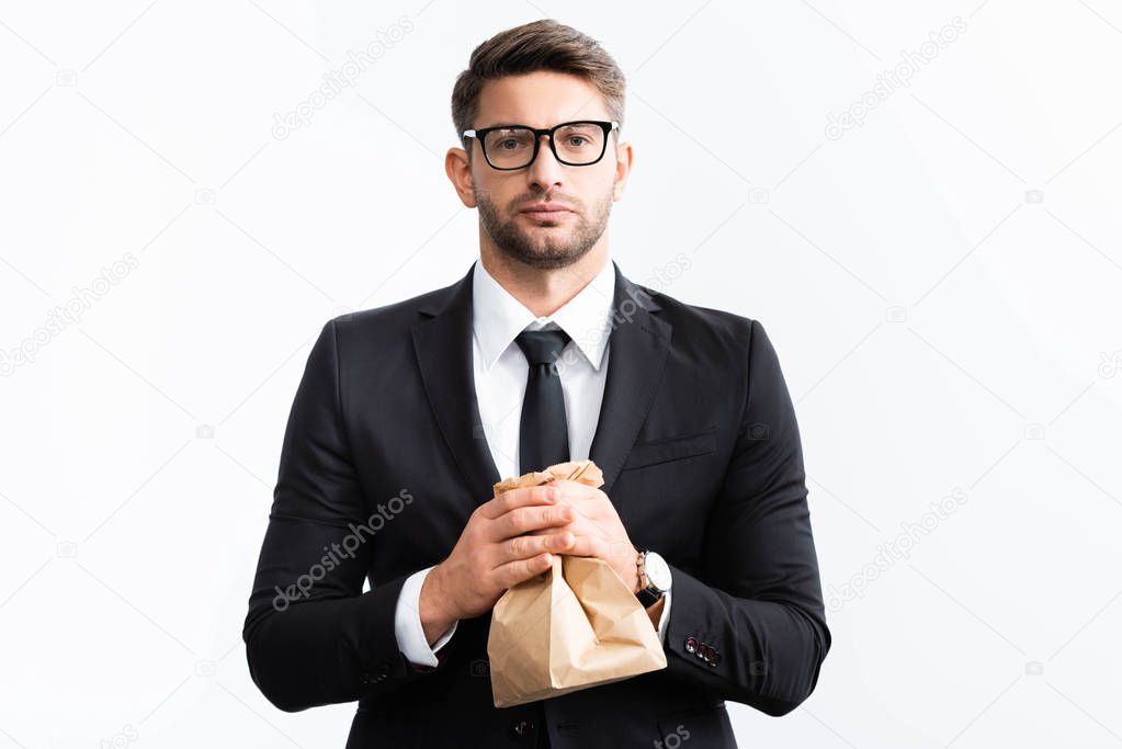 scared businessman in suit holding paper bag during conference isolated on white 