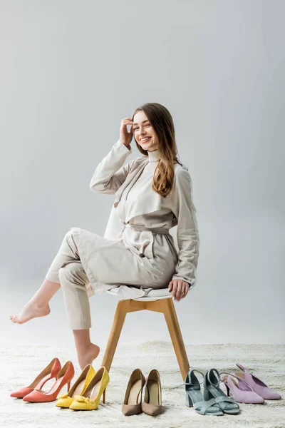 Stylish Barefoot Girl Sitting Chair Collection Shoes Smiling Camera Grey — Stock Photo, Image