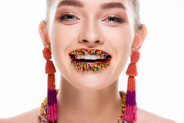 beautiful girl in beaded earrings, with beads on lips, smiling at camera isolated on white