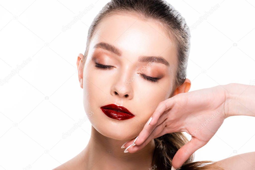 attractive young woman touching face with closed eyes isolated on white