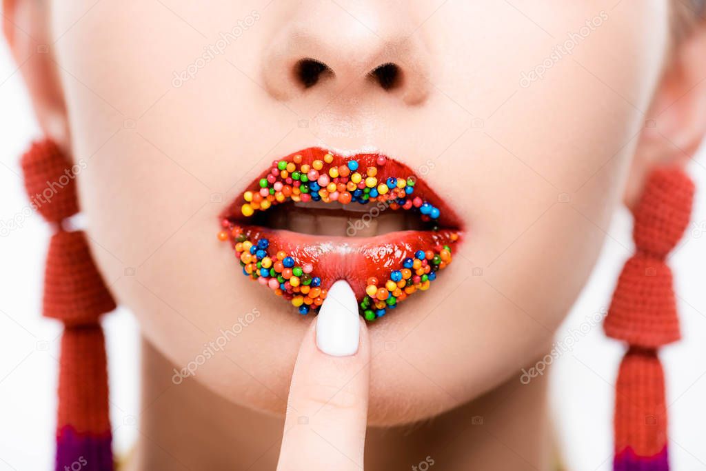 cropped view of girl touching lips, decorated with beads isolated on white