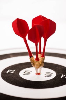 close up of black and white dartboard with red arrows isolated on white  clipart