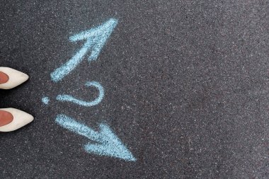 top view of woman standing near directional arrows and question mark on asphalt  clipart