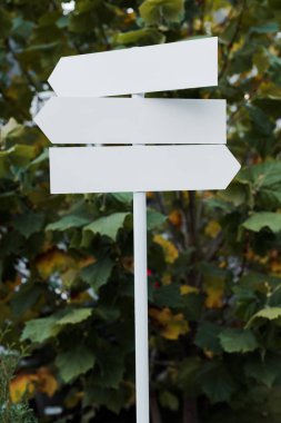 white and empty directional arrows near green leaves  clipart