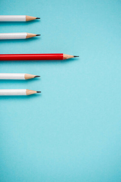 top view of sharpened white and red pencils isolated on blue 