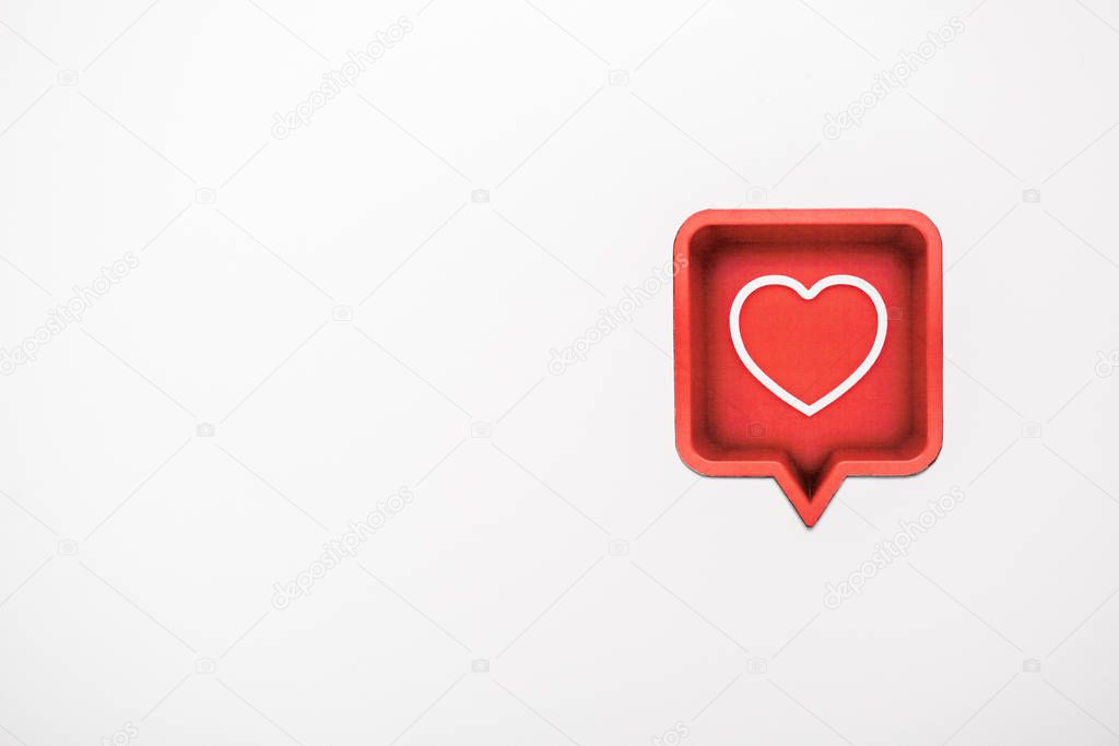 top view of red speech bubble with heart isolated on white 