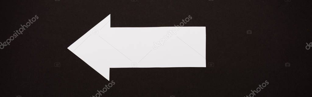 panoramic shot of directional arrow isolated on black 