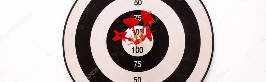 panoramic shot of black and white dartboard with red arrows isolated on white 