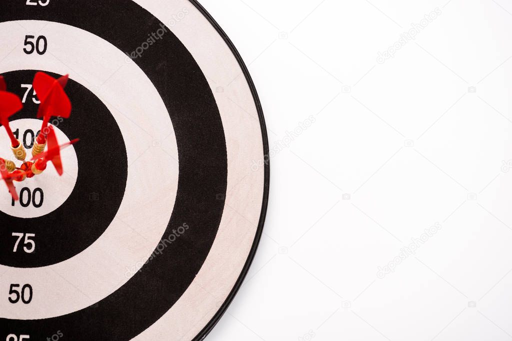 top view of black and white dartboard with red arrows isolated on white 