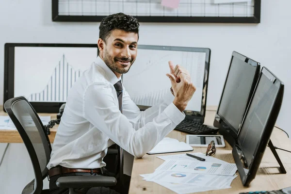 Smiling Racial Trader Showing Thumbs Sitting Computers Graphs — Stock Photo, Image