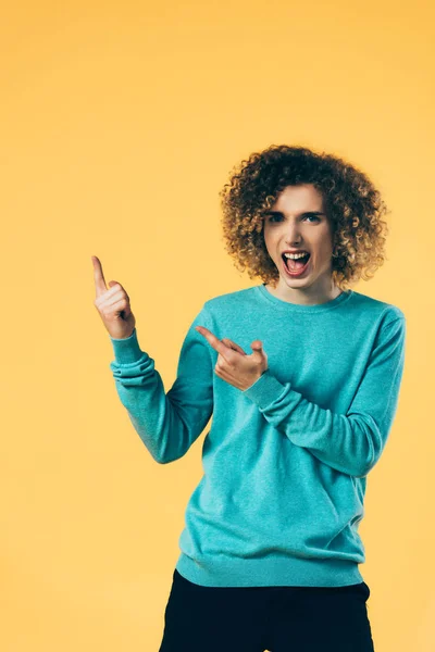 Excited Curly Teenager Open Mouth Pointing Fingers Aside Isolated Yellow — Stock Photo, Image