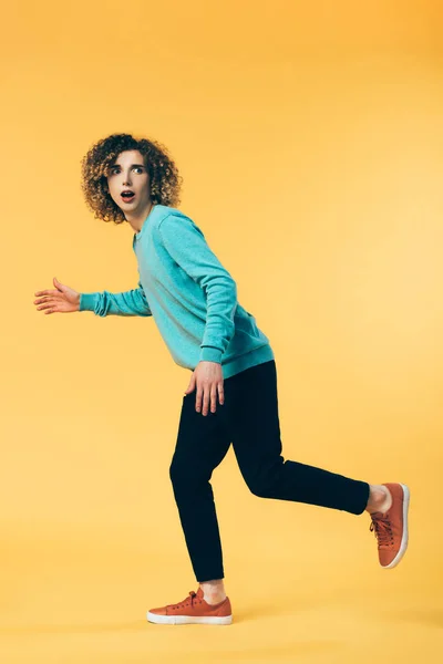 Full Length View Scared Curly Teenager Running Yellow — Stock Photo, Image