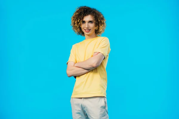 Smiling Curly Teenager Crossed Arms Isolated Blue — Stock Photo, Image