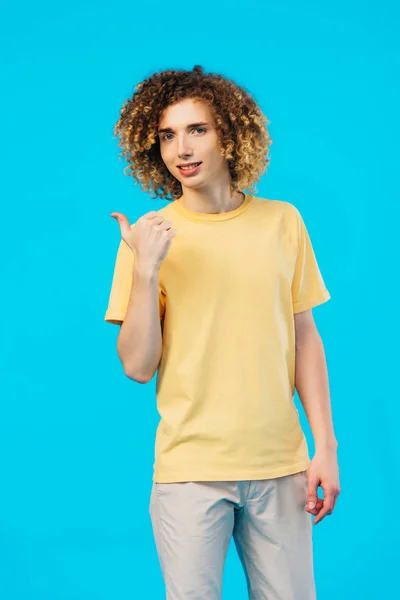 Smiling Curly Teenager Showing Thumb Isolated Blue — Stock Photo, Image