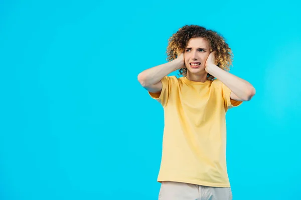 Stressed Curly Teenager Covering Ears Hands Isolated Blue — Stock Photo, Image