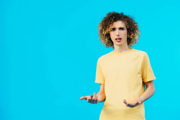 Confused Curly Teenager Showing Shrug Gesture Isolated Blue — Stock Photo, Image