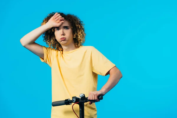 Tired Curly Teenager Riding Electric Scooter Isolated Blue — Stock Photo, Image