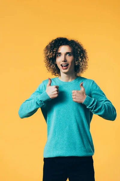 Mad Curly Teenager Showing Thumbs Isolated Yellow — Stock Photo, Image