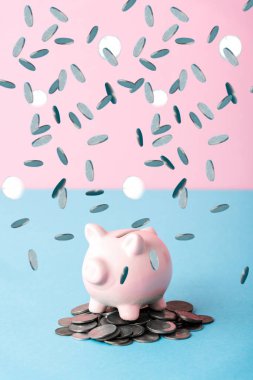 falling silver coins near piggy bank on blue and pink  clipart