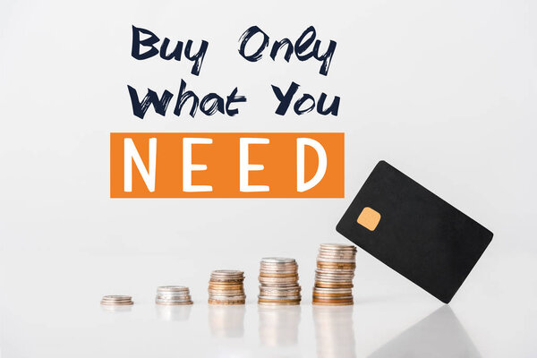 stacks of silver and golden coins near credit card template and buy only what you need letters on white 