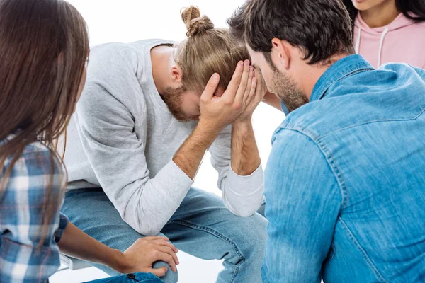 Grupo Apoio Ajudando Homem Estressado Cadeira Isolado Branco — Fotografia de Stock