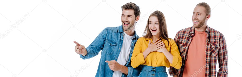 three young friends laughing and pointing with finger isolated on white, panoramic shot