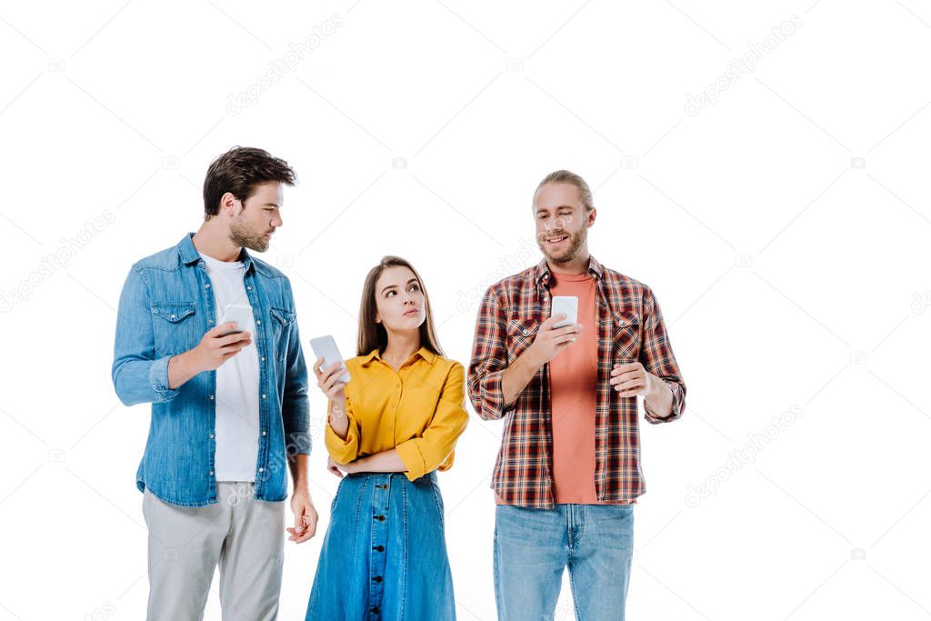 three young friends using smartphones isolated on white