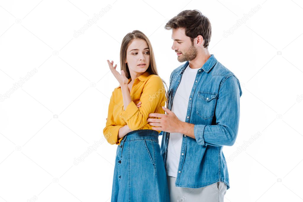 young couple in denim quarreling isolated on white