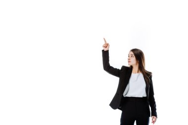 confident businesswoman in suit pointing with finger upwards isolated on white clipart