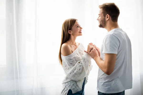 Side View Handsome Man Holding Hands Smiling Woman Apartment — Stock Photo, Image