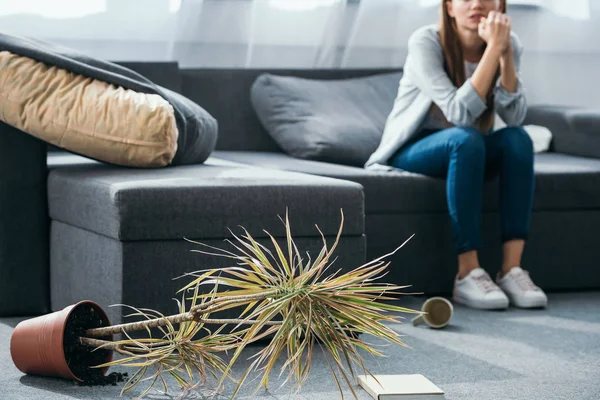 Cropped View Sad Woman Sitting Sofa Robbed Apartment — Stock Photo, Image