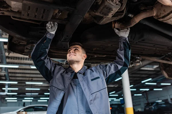 Smiling Mechanic Inspecting Bottom Raised Car Wrench — Stock Photo, Image