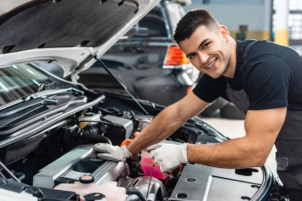 Handsome Mechanic Checking Engine Oil Level Dipstick Smiling Camera — Stock Photo, Image