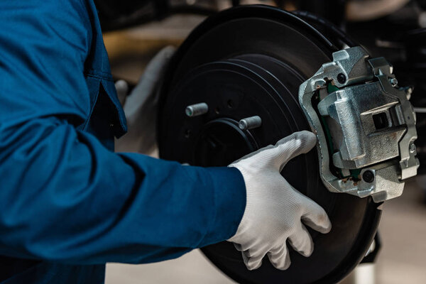 обрезанный вид механической установки дисковых тормозов на автомобиль в мастерской
