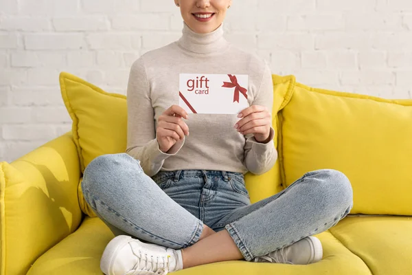 Cropped View Smiling Woman Showing Gift Card Sofa — Stock Photo, Image