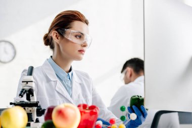Laboratuvarda bilgisayar kullanan moleküler beslenme uzmanının seçici odağı 