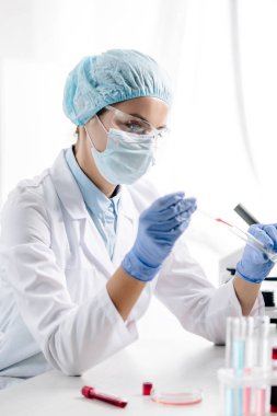 genetic consultant in white coat doing dna test in lab  clipart