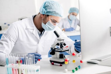 selective focus of genetic consultant doing dna test in lab  clipart