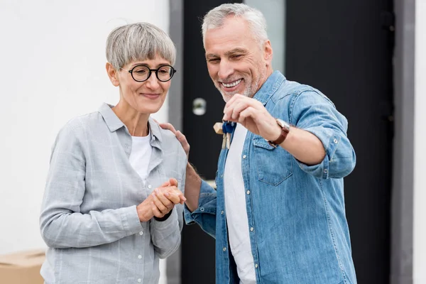 Mature Man Holding Keys New House Smiling Woman Looking — 스톡 사진