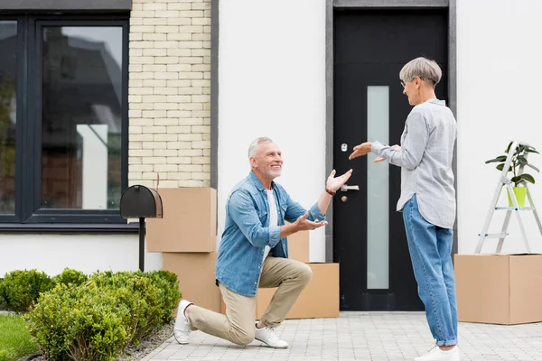 Mature Man Bending Knee Giving Keys New House Woman — Stock Photo, Image