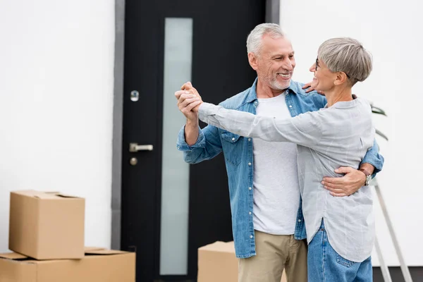 Mature Man Smiling Woman Dancing Looking Each Other New House — 스톡 사진