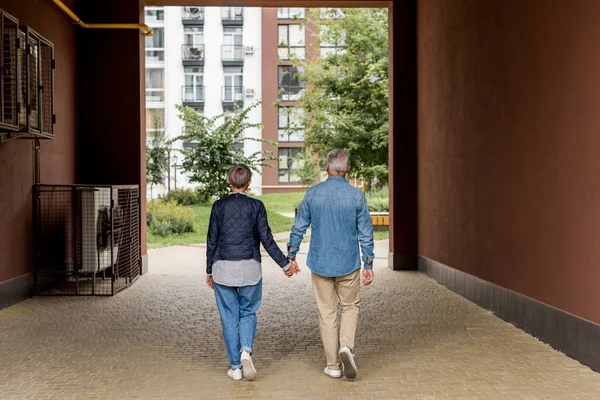 Back View Mature Man Woman Holding Hands Walking New Houses — Stock Photo, Image