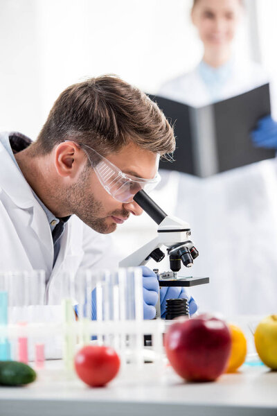 selective focus of molecular nutritionist using microscope in lab 