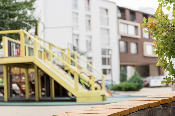 Selective focus of wooden bench and playground on background — Stock Image Selective Focus Wooden Bench Playground Background Stock Photo
