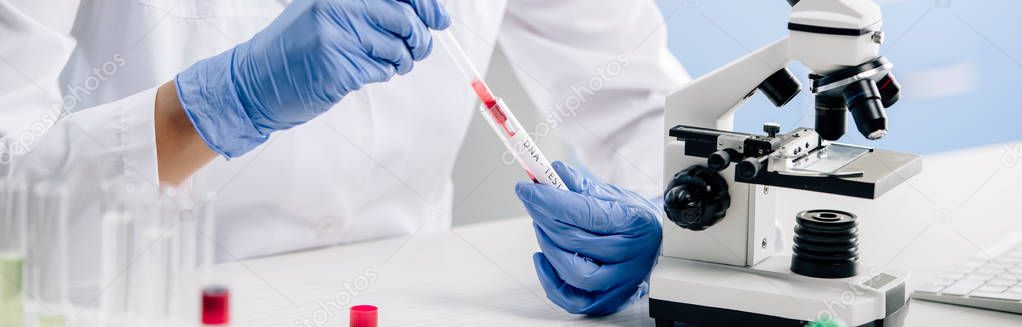 panoramic shot of genetic consultant doing dna test in lab 